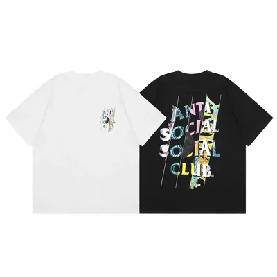 Two short sleeved t-shirts laid side by side on white, one plain cream with a small embroidered motif and one black with a multicoloured cut-out lettering print